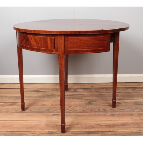 434 - A mahogany demi lune fold over table with lockable drawer and key.