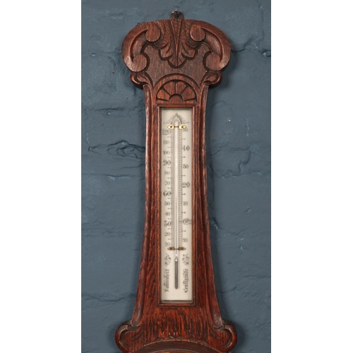 386 - An oak carved banjo Barometer. Patent no 16536. H: 85cm W:25cm.