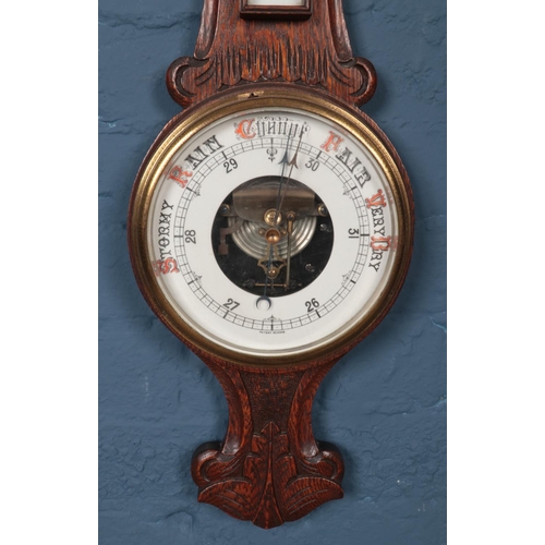 386 - An oak carved banjo Barometer. Patent no 16536. H: 85cm W:25cm.