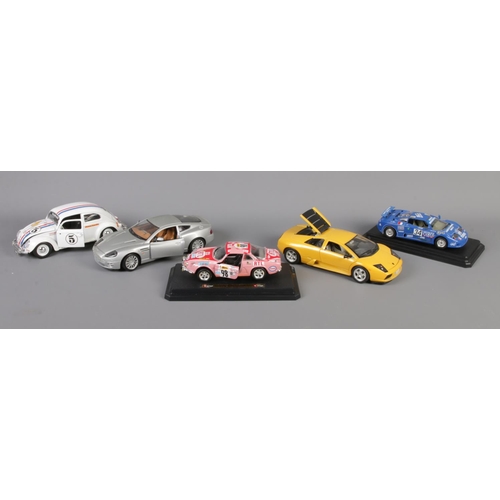 310 - A collection of five boxed Burago metal kit scale models. To include 2002 Aston Martin Vanquish (1/1... 