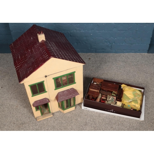 324 - A white two storey dolls house with box of furniture and accessories.