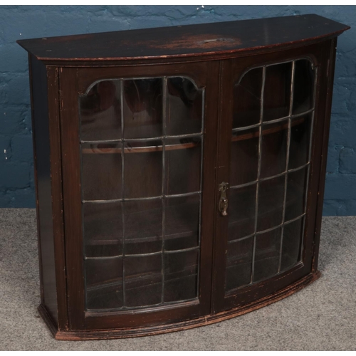 326 - An oak bow front wall mounted display cabinet.