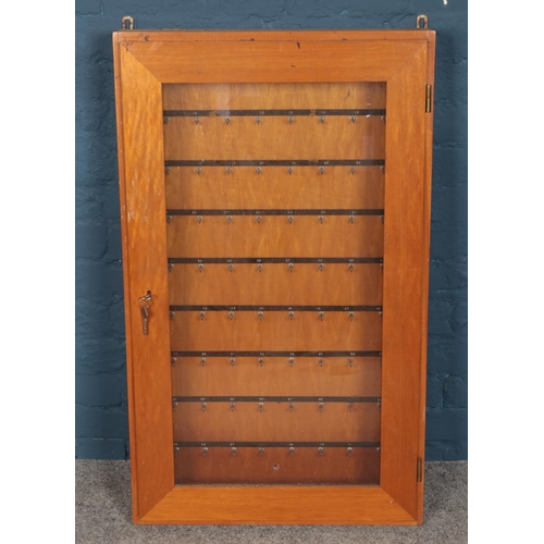 327 - A wooden wall mounted key cabinet.