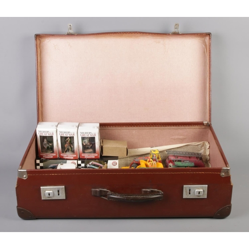 333 - A leather suitcase containing an assortment of mainly boxed and loose diecast vehicles and figures. ... 