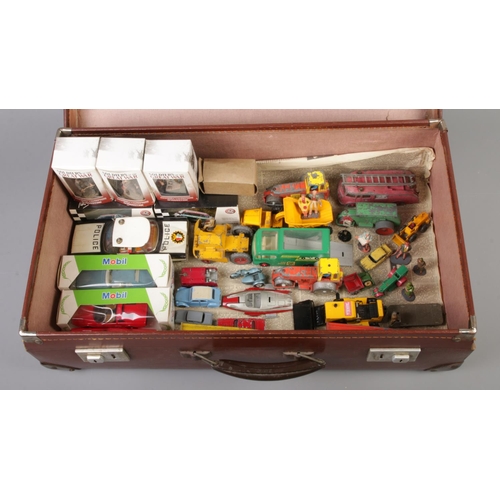 333 - A leather suitcase containing an assortment of mainly boxed and loose diecast vehicles and figures. ... 