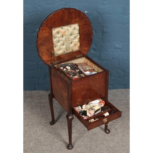 346 - A walnut sewing box with contents of sewing equipment.