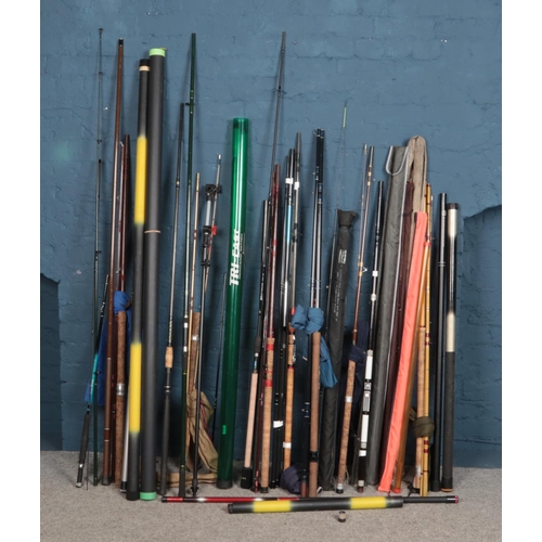 351 - A large collection of fishing rods. Includes Shakespeare, Millbro etc.