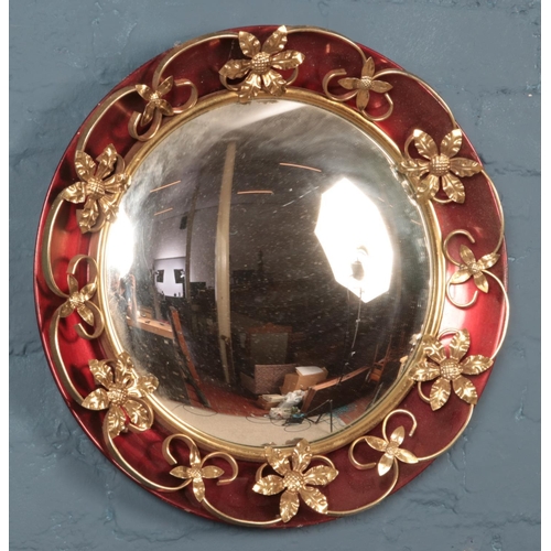 359 - A decorative convex mirror with gilt metal floral surround. Diameter 48cm.