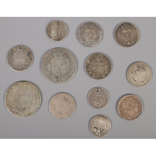 437 - Twelve early 19th century silver coins. Including George III examples, etc.  71g.