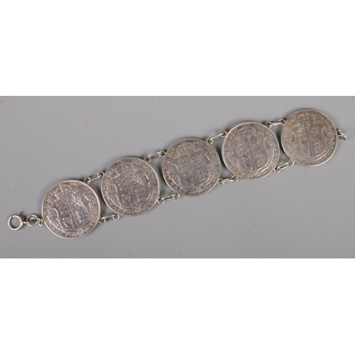 468 - A George V half crown bracelet. Made up of five half crowns dated 1916 and 1918.