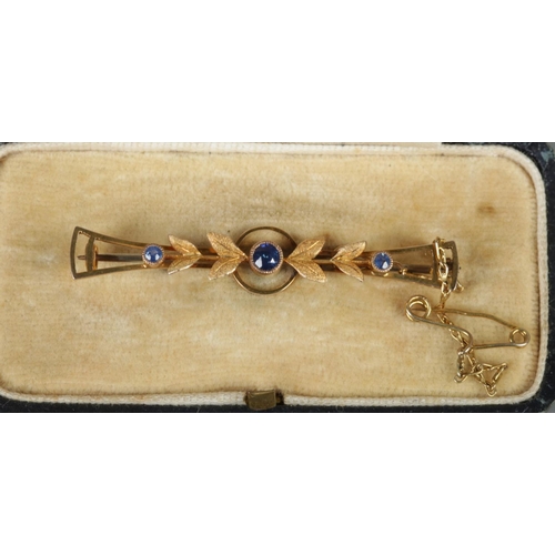 470 - A cased 9ct gold bar brooch set with three sapphires. 2.43g.