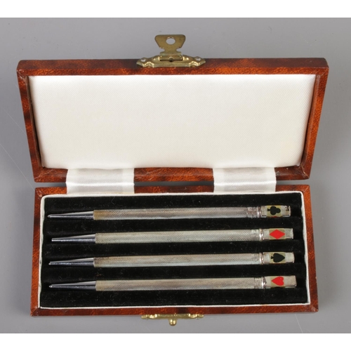 502 - A cased set of sterling silver propelling bridge pencils.