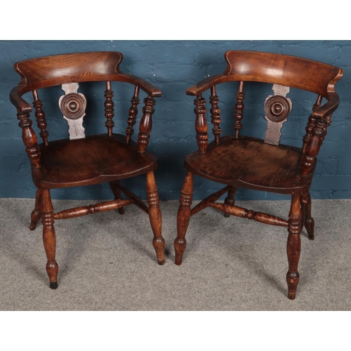 508 - A pair of carved oak smokers bow armchairs. With turned column back rests and legs.