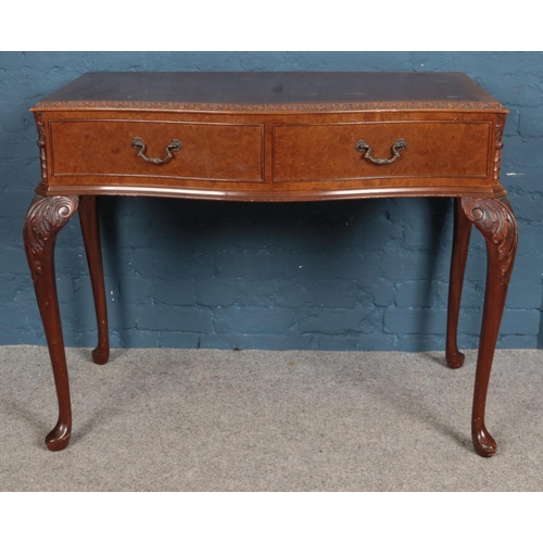 539 - A Queen Anne style walnut serpentine sideboard, with glass top, and carved edging and cabriole feet,... 