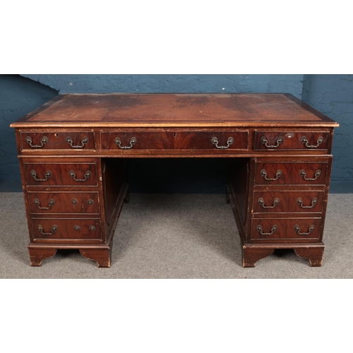 555 - A large mahogany twin pedestal knee hole desk. With inset top. (77cm x 152cm x 90cm)