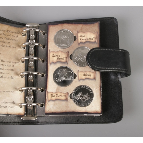 90 - A Harry Potter coin collection in Gringotts Savings Book display binder.