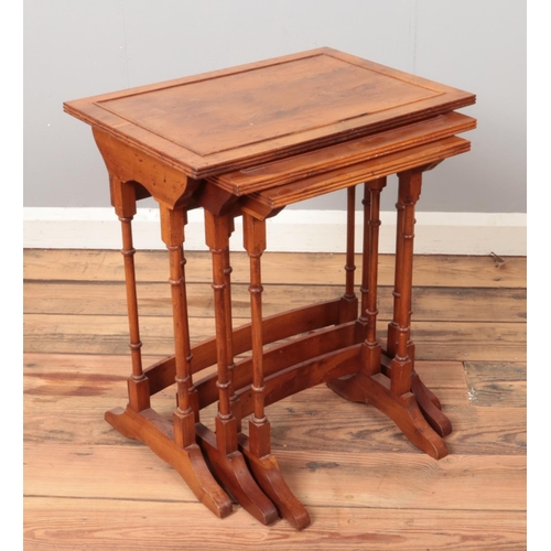 502 - An Edwardian style nest of three walnut tables.