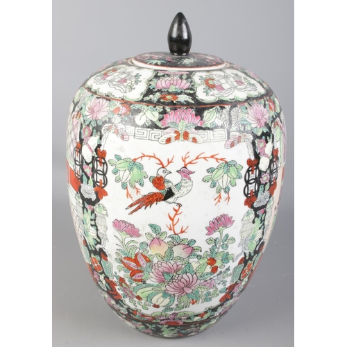 110 - A oriental lidded vase. With hand painted decoration depicting figures, birds and flowers. (31cm)