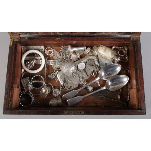 168 - A Nineteenth century mahogany writing slope containing silver watch cases, charms, and silver and wh... 