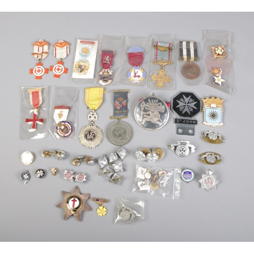 69 - A quantity of badges and medals mainly St. Johns Ambulance and British Red Cross.