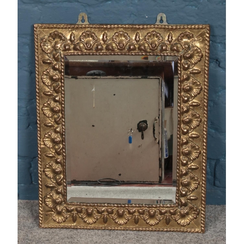 358 - A brass framed bevel edged mirror mirror, with shell decoration and rope twist border. Height: 55cm,... 