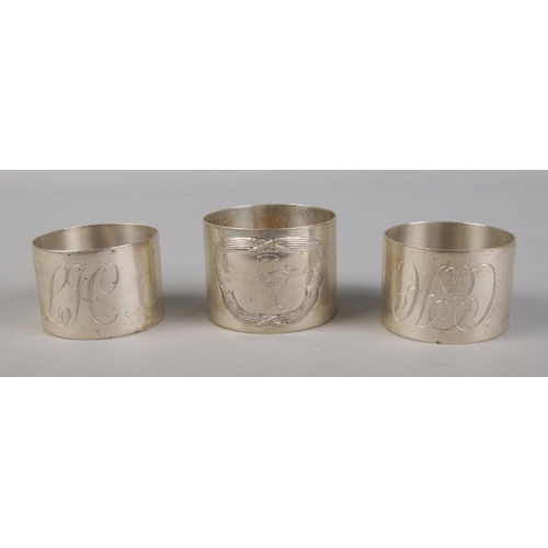 363 - A trio of silver napkin rings, including one matching pair (Assayed Birmingham 1984). Single ring ha... 