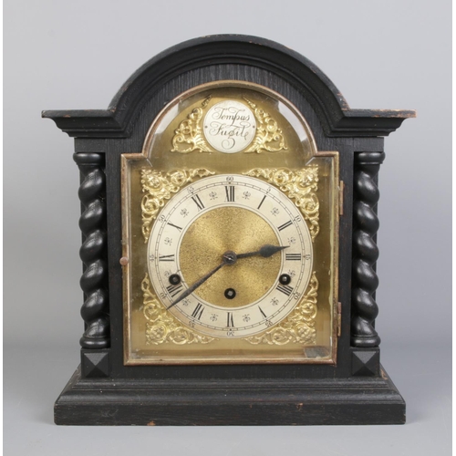 75 - A Tempus Fugit wooden cased mantle clock, with barley twist supports. 37cm high.