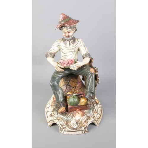 78 - A Capodimonte figure of man with watermelons.