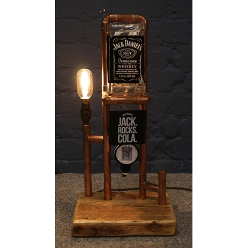 86 - Two copper pipe mounted Jack Daniels optics, with table lamps.