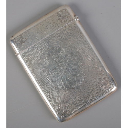 486 - A silver card case with etched floral decoration. Assayed Birmingham 1909 by Charles S Green & Co Lt... 