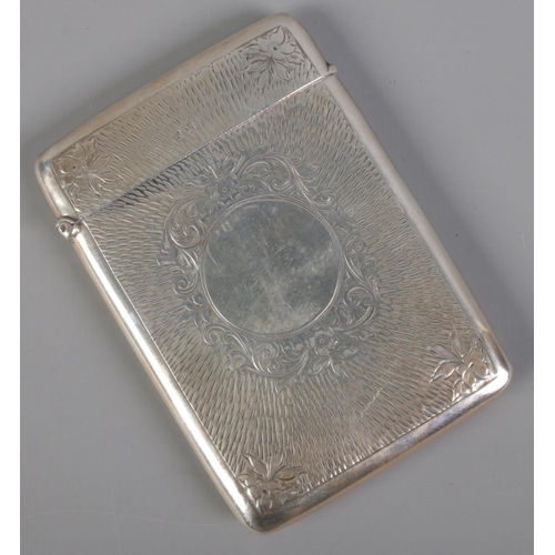 486 - A silver card case with etched floral decoration. Assayed Birmingham 1909 by Charles S Green & Co Lt... 