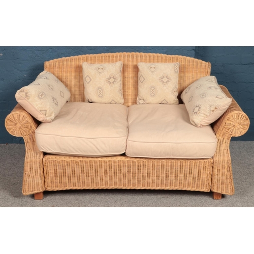 507 - A large wicker 2 seat conservatory settee. Height: 87cm, Width: 157cm, Depth: 93cm.