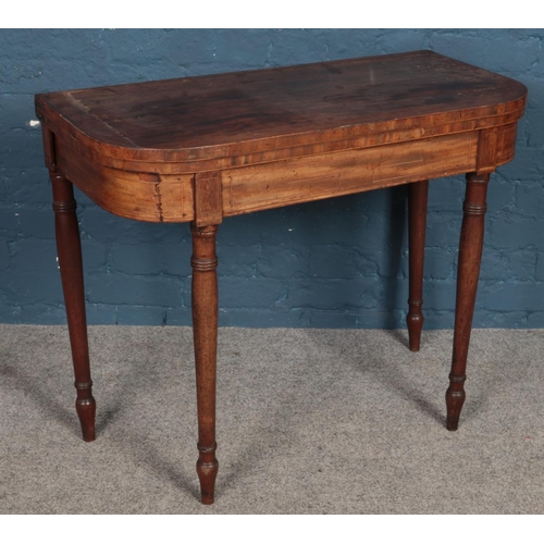 509 - A Victorian mahogany fold over card table.