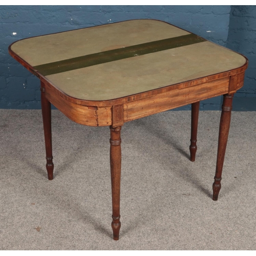 509 - A Victorian mahogany fold over card table.