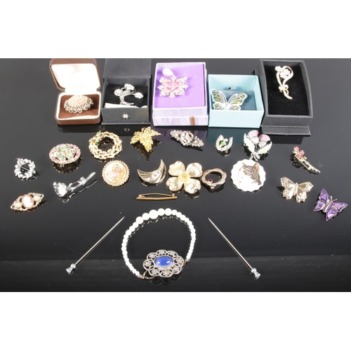 187 - Various costume jewellery brooches and two hat pins.