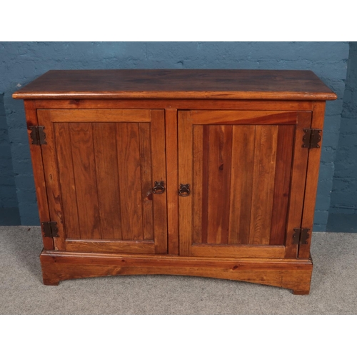 494 - A stained pine sideboard. H90 x L120 x W47cm