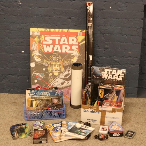 224 - Two boxes of Star Wars collectables. Including figures, Anakin Skywalker Starfighter puzzle, tins, p... 