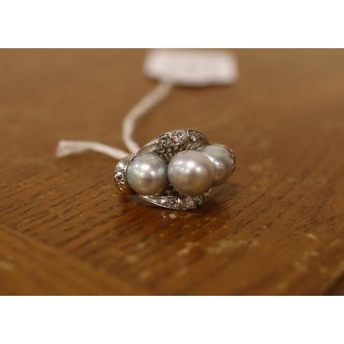 384 - A vintage white metal cultured pearl and diamond cocktail ring. Size M½. Total weight: 7.68g