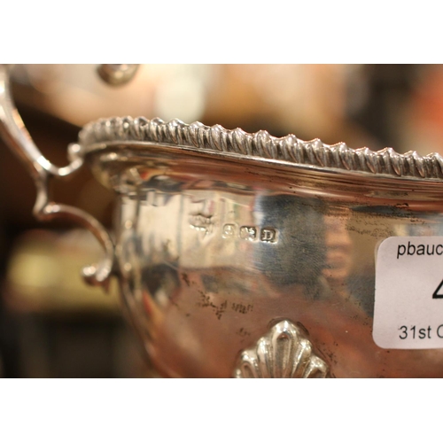 453 - A silver sauceboat with scrolled handle. Assayed Birmingham 1928 by Mappin & Webb. 279g.