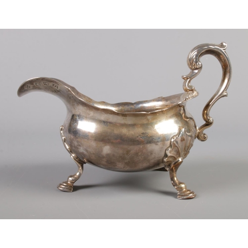 104 - A George II silver sauce boat raised on three scrolled feet. Assayed London 1759 by Simon Le Sage. 4... 