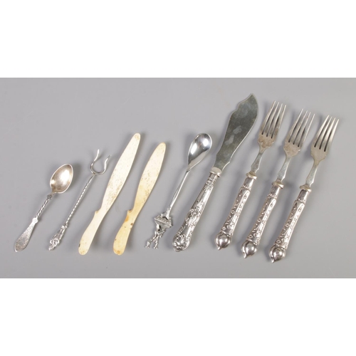 108 - A collection of antique cutlery. Includes silver handled and white metal examples, bone peelers etc.