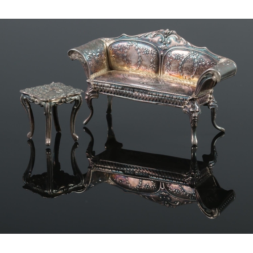 111 - An early 20th century silver continental sofa, along with a similar white metal table. Possibly doll... 