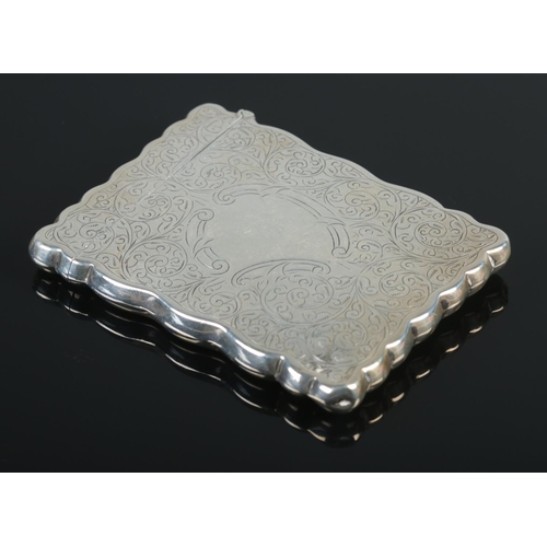 113 - An Edwardian silver card case with engraved decoration, embossed with a scene depicting a courting c... 