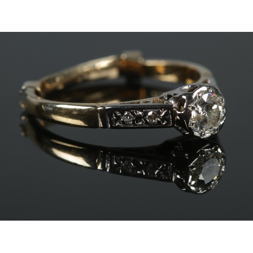 126 - An 18ct gold platinum and diamond ring. A single stone (0.25ct) flanked by diamond set shoulders. Si... 