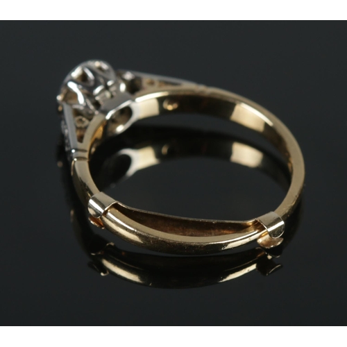 126 - An 18ct gold platinum and diamond ring. A single stone (0.25ct) flanked by diamond set shoulders. Si... 