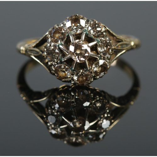 128 - An 18ct gold diamond cluster ring. Approximately 1.25ct diamond. Size P. 3.4g.