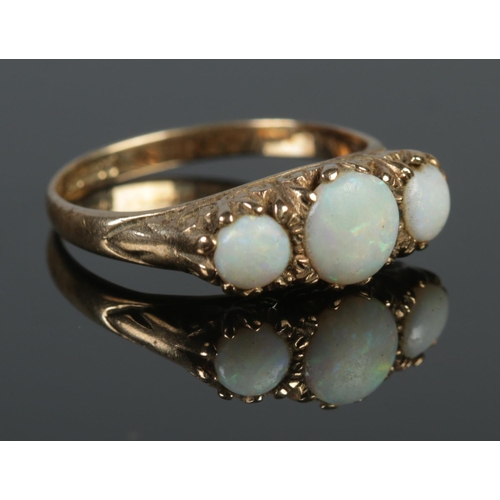 129 - A vintage 9ct gold and three stone opal ring. Size P 1/2. 3.76g.