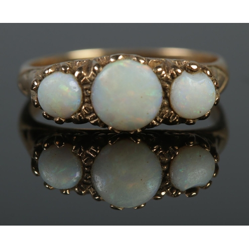 129 - A vintage 9ct gold and three stone opal ring. Size P 1/2. 3.76g.