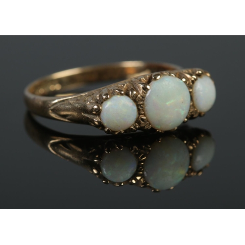 129 - A vintage 9ct gold and three stone opal ring. Size P 1/2. 3.76g.