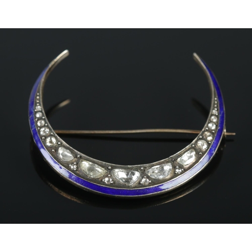 132 - A vintage white metal and enamel crescent formed brooch set with nineteen rough cut diamonds. Approx... 